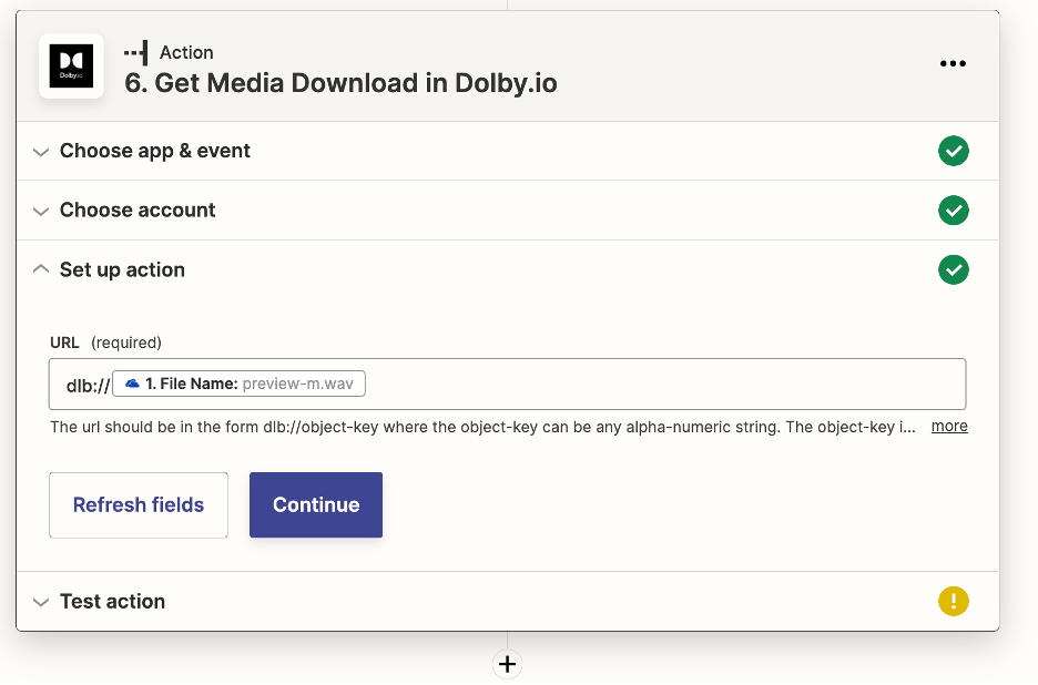 This is the 'set up action' menu for the event 'Get Media Download in Dolby.io.' There is a textbox shown asking for a 'URL.' In the box is 'dlb://1. FIle Name: preview-m.wav' Hand typed is 'dlb://' while the filename is selected from the drop down menu. The exact file name will be different user to user.
