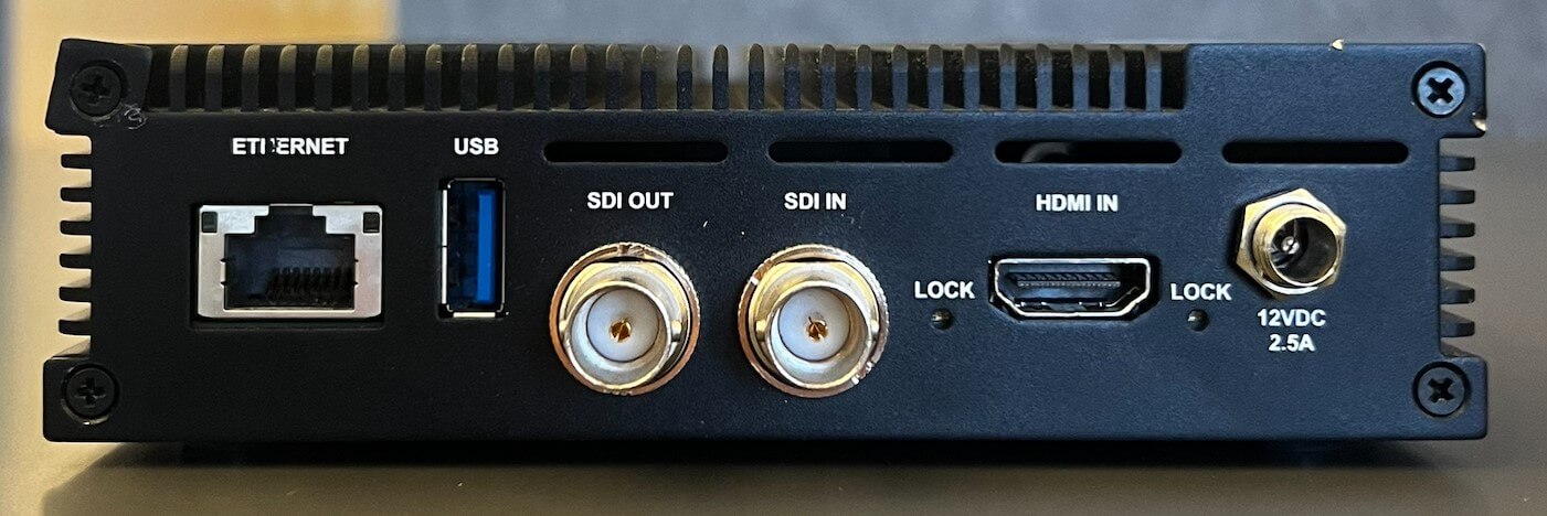 The image depicts the back of the encoder including an ethernet connection, usb connection, SDI out connection, SDI in connection, HDMI in connection, and a 12VDC 2.5A power connection.